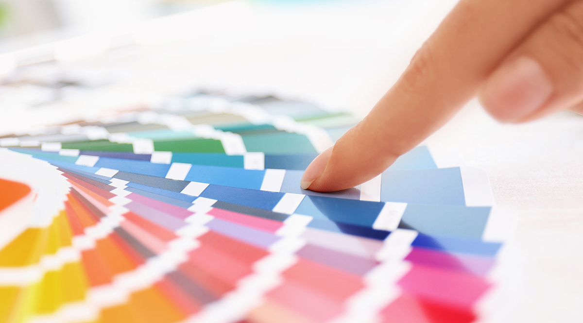 Woman with paint color palette samples, closeup